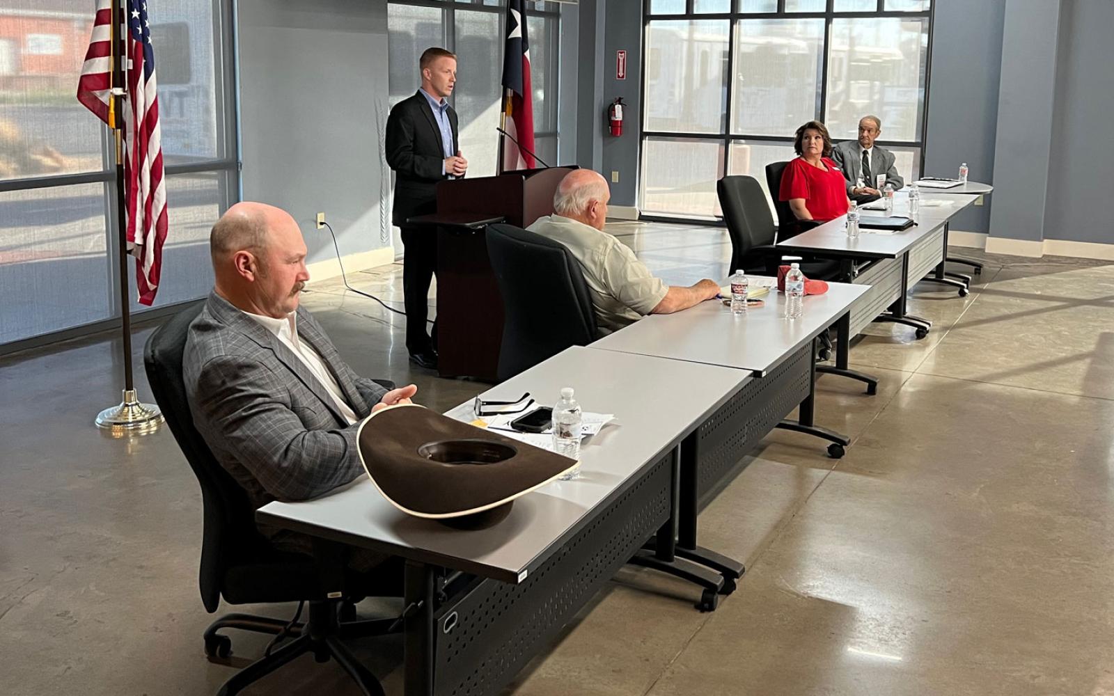Candidates Shawn Nanny and Bill Ford (for commissioner pct. 4), along with Pct 3 JP candidates Stacye Speck and Ron Perry listen to County Judge Candidate Lane Carter speak.