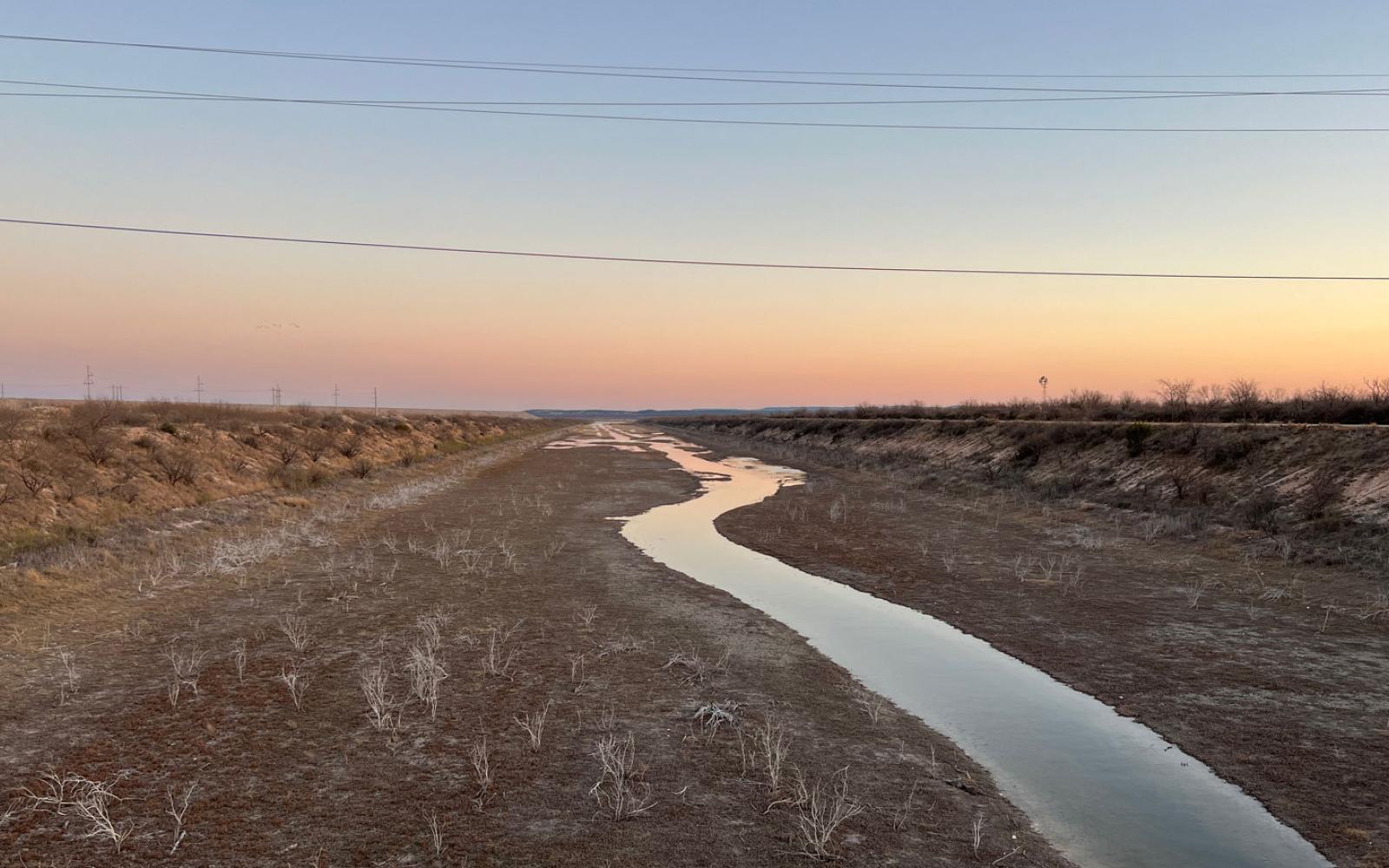 The South Concho river flows into the south pool of the Twin Buttes Reservoir system that connects the south and north pools with an equalization channel pictured here.