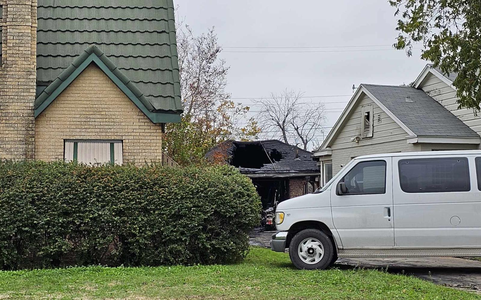 The following day, a van blocks the view to the fire in a garage that happened on Nov. 24, 2023