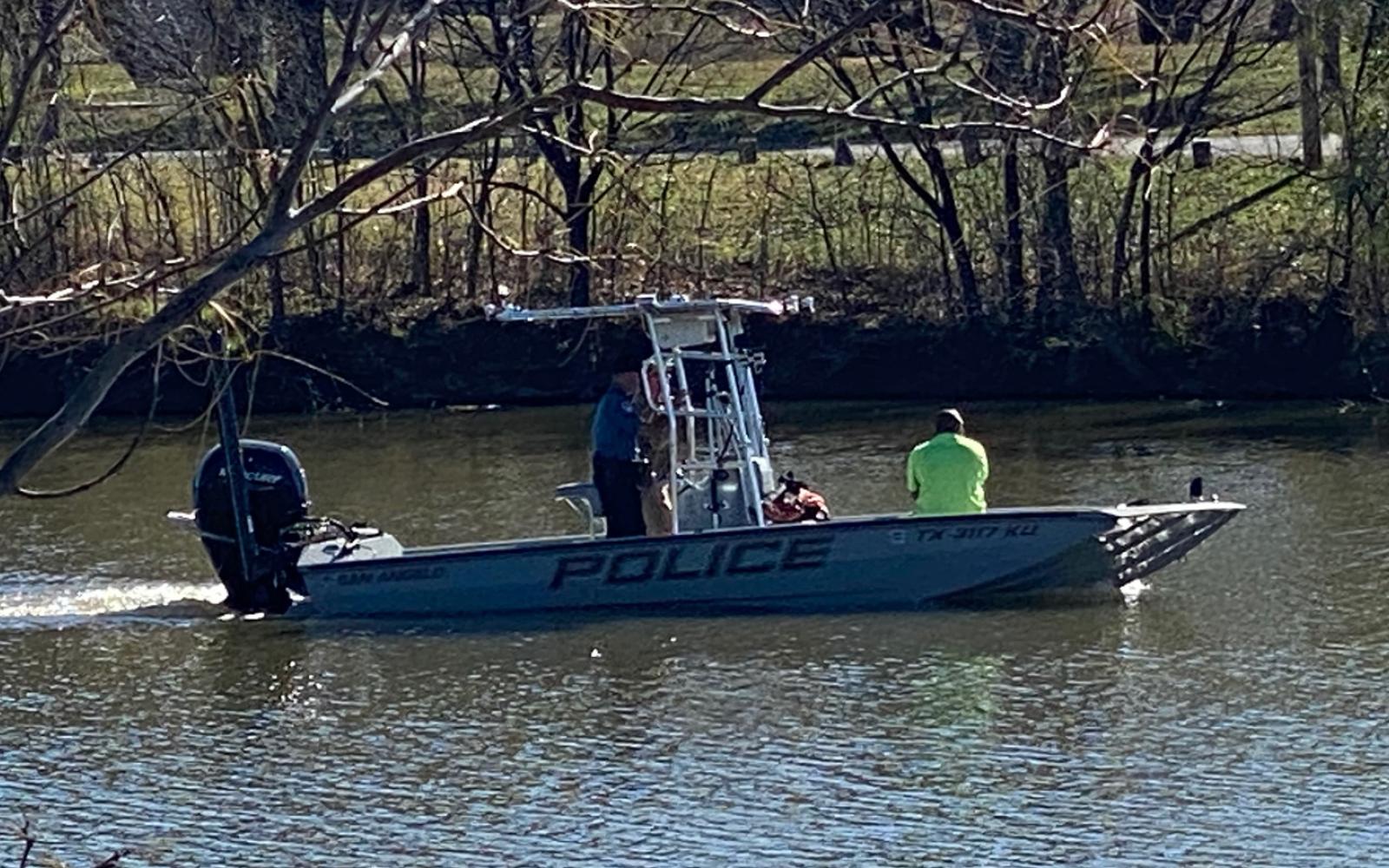 Police fish a car out of the Concho River