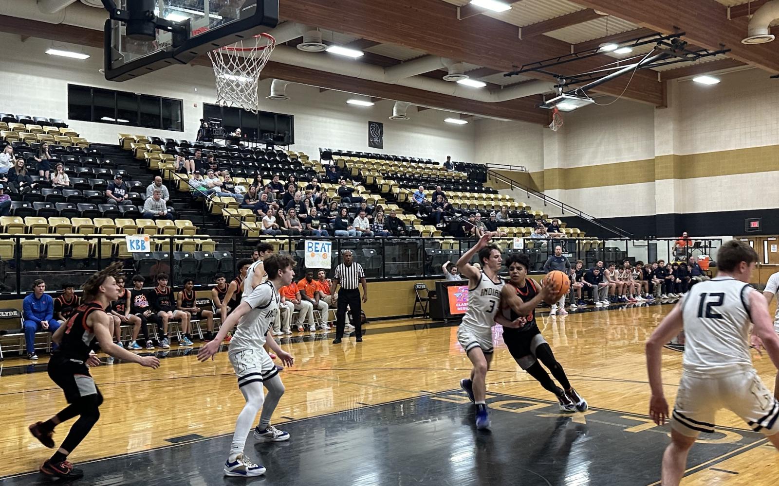 Bobcats' Squeaky English drives towards the basket against Keller