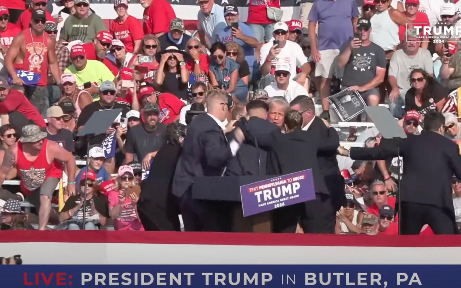 Donald Trump gets up with aid of secret service after shots ring out at his rally in Butler, PA, on July 13, 2024