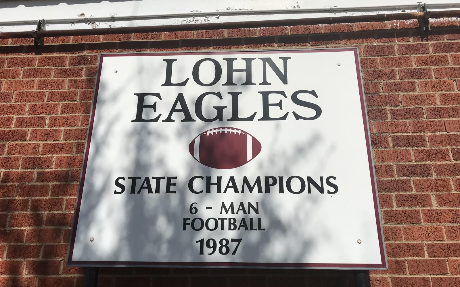 Lohn High School's sign commemorating its 1987 six-man football state championship.
