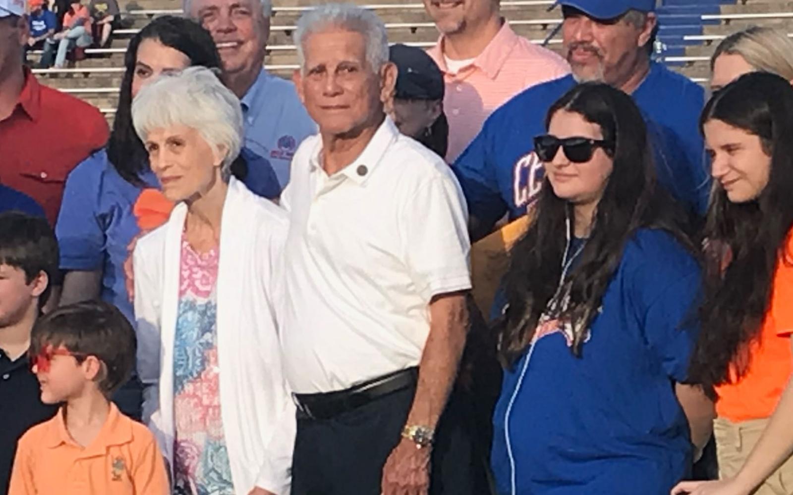 Mr. Manuel Gonzales is with his wife, Amanda, and surrounded by his children and grandchildren for the presentation of his high school diploma.