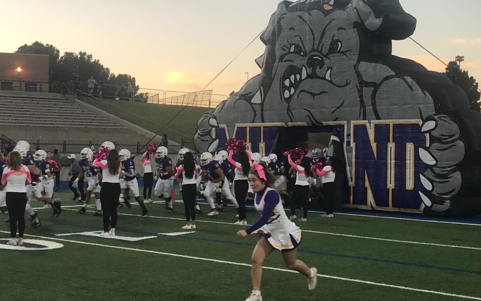 The Midland High Bulldogs charge out of their tunnel before their game against San Angelo Central on Friday, Oct. 25, 2024.