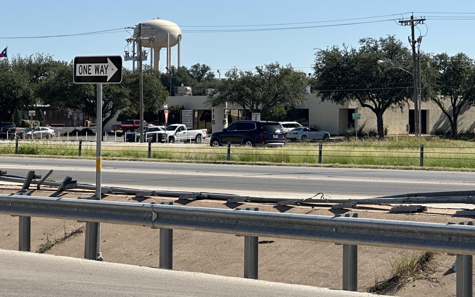 A damaged guardrail along W Loop 306 shows the impact from the vehicle rollover near the College Hills Blvd intersection. The cause of the crash is still under investigation.