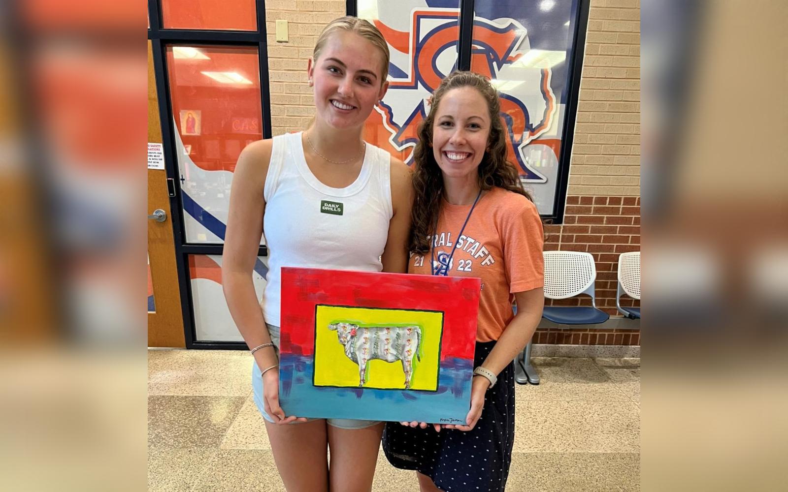 Pictured: Korbin Jastrow with her winning piece with Central High School art teacher Heather Shoop-York. 