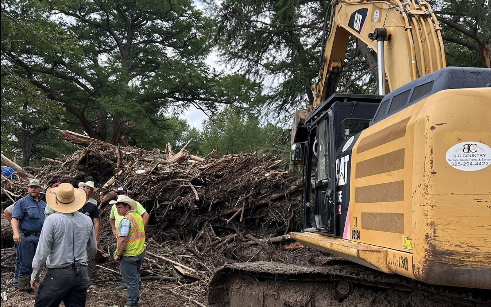 Workers sift through debris from the Guadalupe River flooding.