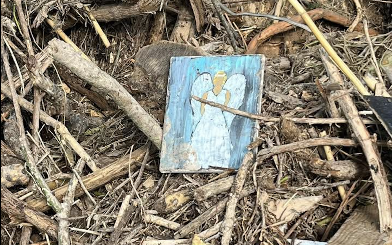 A small drawing is shown in the debris from the Guadalupe River flooding.