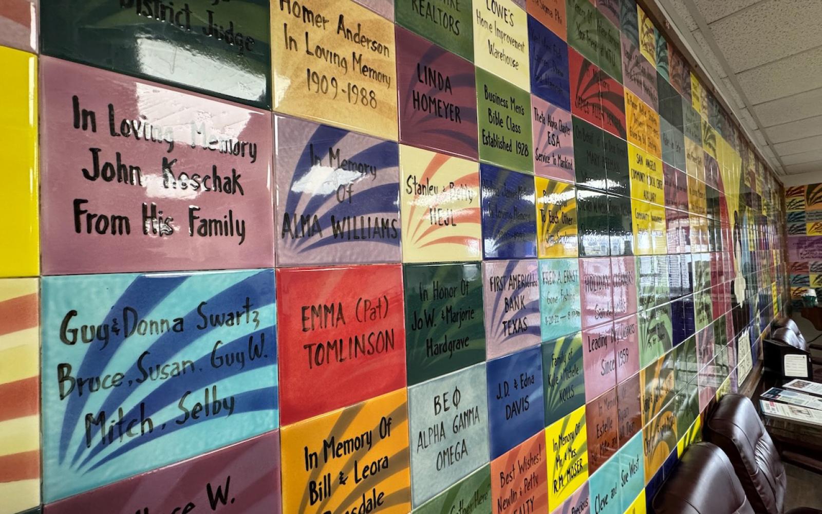 The wall of tiles honoring past and present donors and volunteers of Meals for the Elderly.