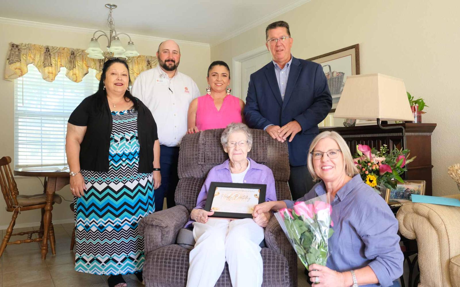From left, Norma Dietz Lee, executive director of Meals for the Elderly; Lane Strickland, vice president; Suzannah Valenzuela, director of marketing; San Angelo Mayor Tom Thompson; seated, honoree Ida Walter; and kneeling, Karla Thompson, gather Friday to celebrate Walter’s 101st birthday.