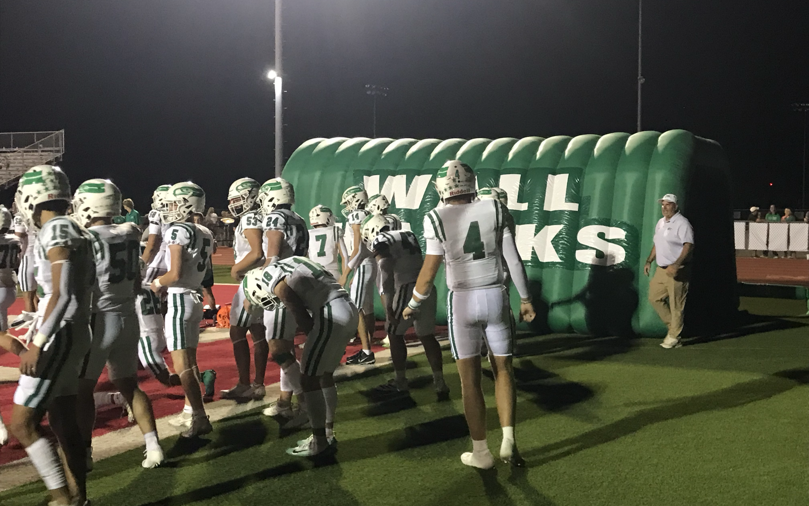 Quarterback Landon York (4) and the Wall Hawks warm up at halftime of their game with Jim Ned on Friday, Sept. 12, 2025, in Tuscola.