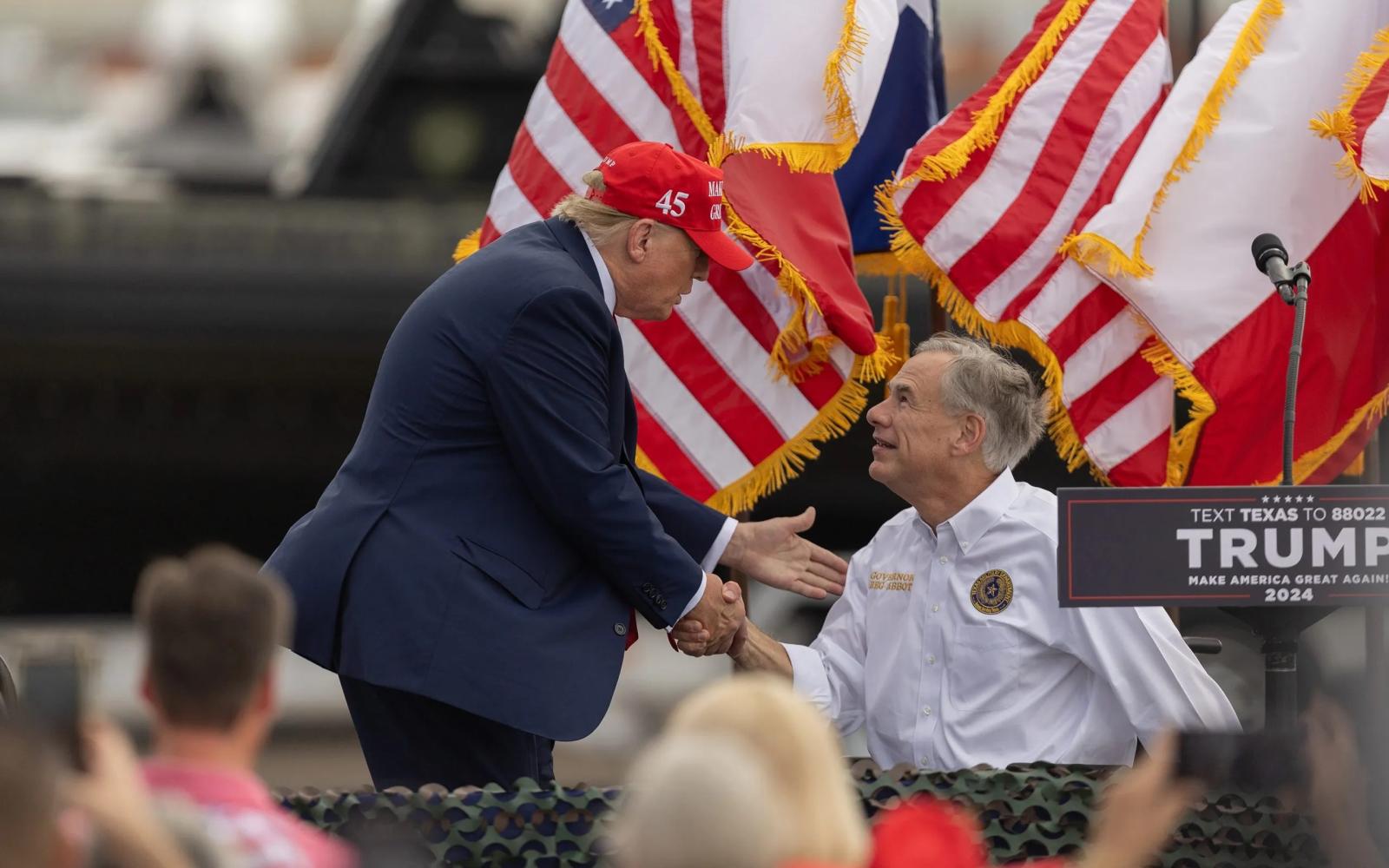 President Donald Trump greets and shakes hands with Gov. Greg Abbott in Edinburg on Nov. 19, 2023. Trump on Tuesday endorsed Abbott, who is seeking a fourth term as Texas governor.  Eddie Gaspar/The Texas Tribune
