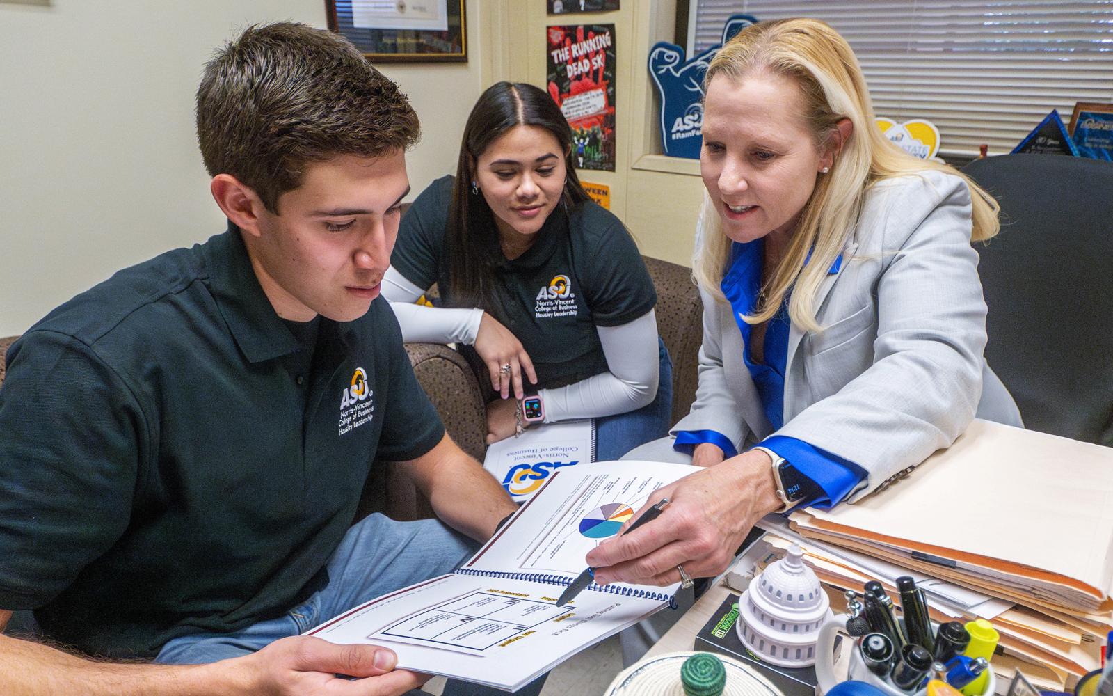 ASU business professor, Dr. Gayle Randall, working with students in her office