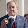 Texas Attorney General Ken Paxton, left, next to his wife and Texas State Sen. Angela Paxton, speaks to anti-abortion activists at a rally outside the Supreme Court, Monday, Nov. 1, 2021, on Capitol Hill in Washington. (AP Photo/Jacquelyn Martin)